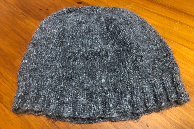 Wool Sheep Farm Experience with Handmade Wool Hat in New Zealand - Trying your hand at wool spinning